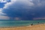 Storm clouds roll in over the bay at Mordialloc.